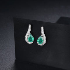 White Gold and Pear shape Emerald Earrings.