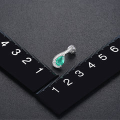 White Gold and Pear shape Emerald Earrings.