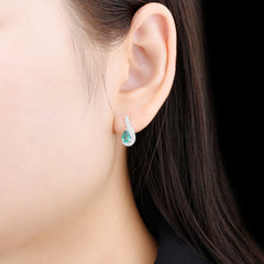 White Gold and Pear shape Emerald Earrings.